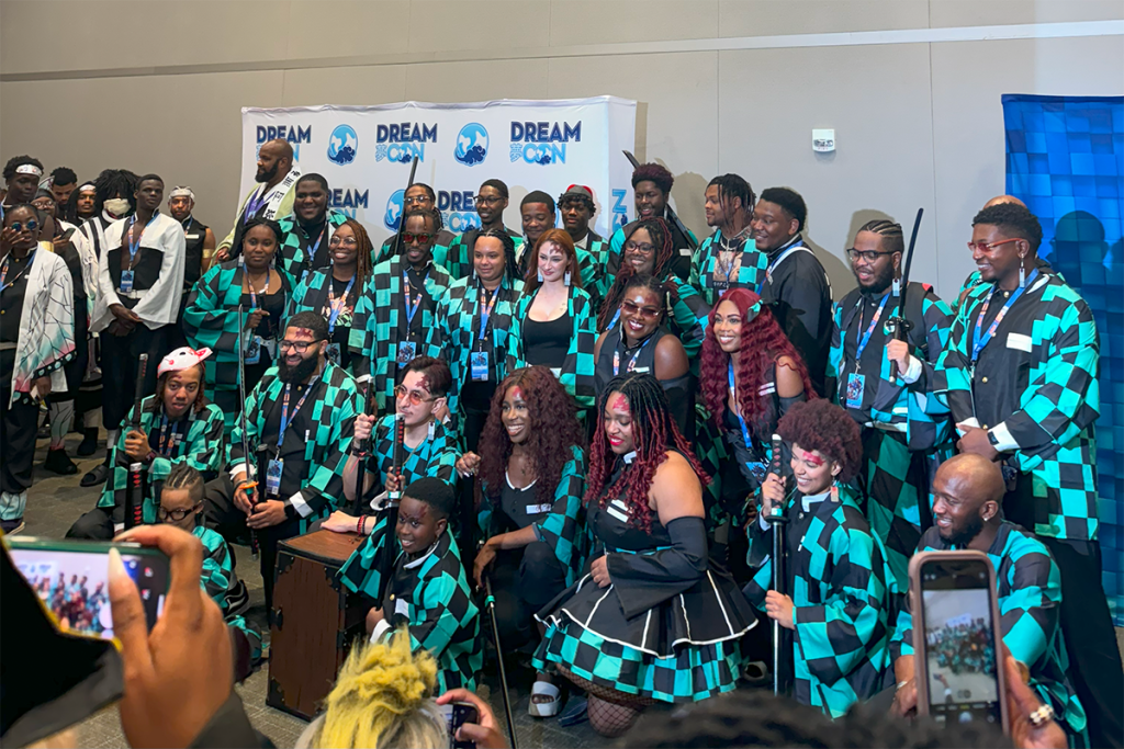 Cultural Innovation in Marketing: AI, UGC, and Experiential Events 3 Black Demon Slayer Cosplayers at Experiential Event creating UGC